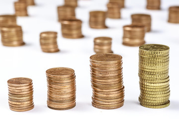 Piles of different eurocent coins on white