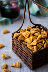 Chips (Snacks) and Beverage on a white wooden surface.
