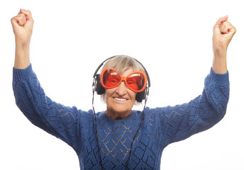 Funny old lady listening music and showing thumbs up. 