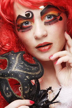 Beautiful redhair woman with mask.
