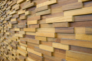 exposed wooden wall exterior, patchwork of raw wood forming a beautiful parquet wood pattern.