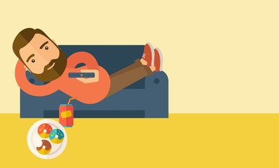 Man lying in the sofa holding a remote.