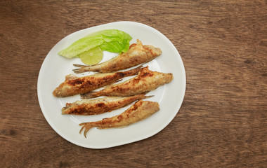 fish smelt fried in a plate. top view