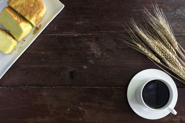 Coffee cup and saucer with wheat and cake