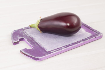 Purple eggplant on a cutting board