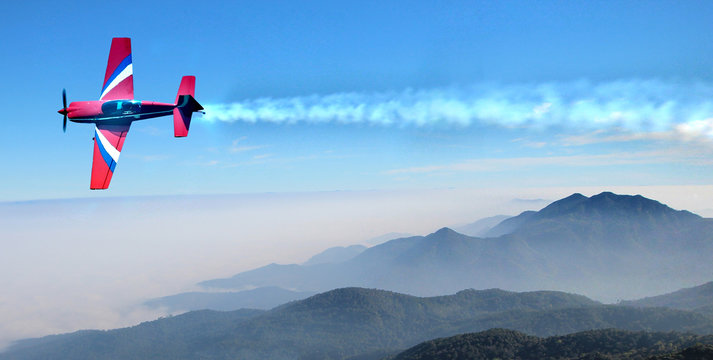 Small airplane in the sky above the mountains