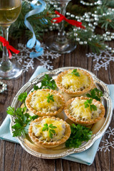 Holiday appetizer: tartlets with mushrooms and meat on a celebra