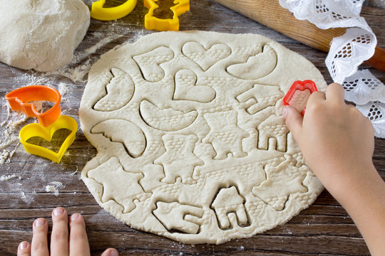 Child sculpts Christmas decorations from salt dough. Children's