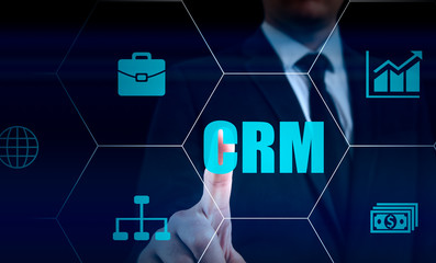 business, technology, internet and customer relationship management concept. Businessman pressing crm button on virtual screens