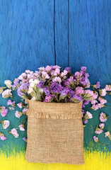 Beautiful flowers on the wooden floor, yellow and blue.