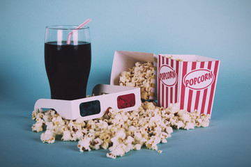 Popcorn bucket against a blue background Vintage Retro Filter.