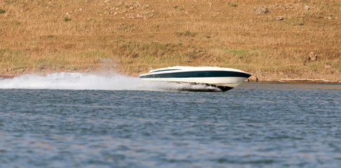 Boat floats on the lake speed