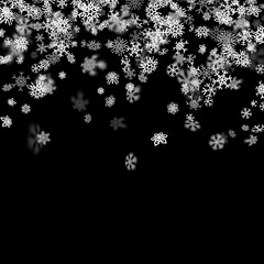 Snowfall background with snowflakes blurred in the dark