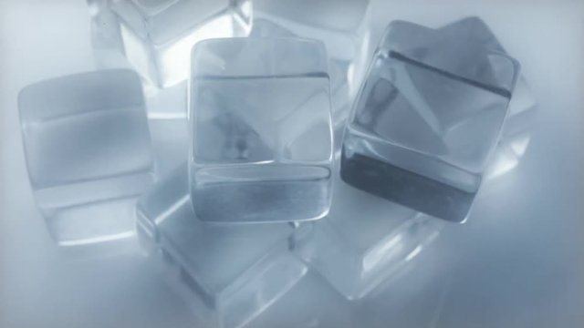 Acrylic ice cubes slowly rotate with steam flowing over. HD 1080.