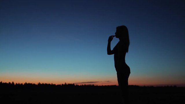 femle silhouette exhalation smoke from cigarette