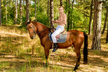 young man in the forest on horseback