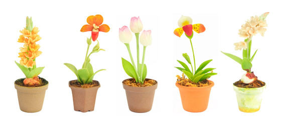 various fake flower sets in flowerpot on white background