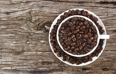 beans coffee in white cup on ancient table