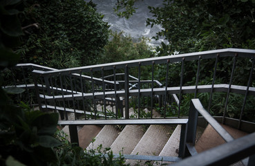 Obraz premium Rusty stairs followed from the forest to the coast