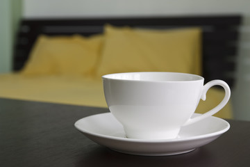 hot coffee or tea on table in bedroom