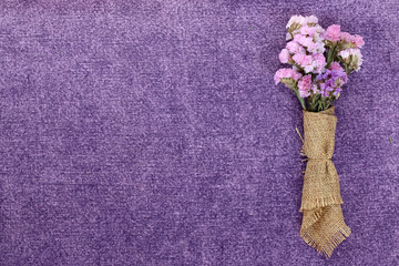 Beautiful flowers on a purple fabric.
