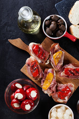 Spanish tapas with slices jamon serrano and grilled pepper. Also
