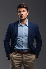 Fototapeta premium Handsome young confident man standing with hands in pockets