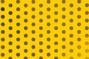 yellow background in a black polka dots, metal plate in the hole