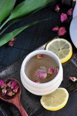 Rose Tea on Tray with Green Leaves on Background