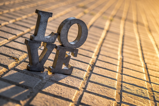 Love sign with metal letters in a street