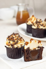 Homemade chocolate cupcakes with caramel topping and chocolate chips (selective focus)