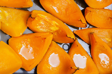 Bright orange pumpkin on baking baked with honey