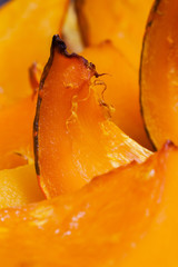 Vivid orange colour slices of baked pumpkin with a honey, hot dessert in autumn
