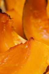 Sliced of grilled vivid pumpkin close up, hot dessert in autumn