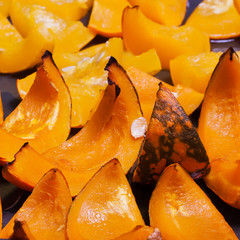 Bright orange pumpkin on a baking baked with honey