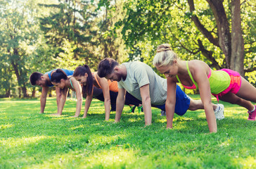 group of friends or sportsmen exercising outdoors