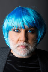 Man in blue wig on grey background