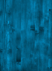 A blue wooden wall with vertical planks