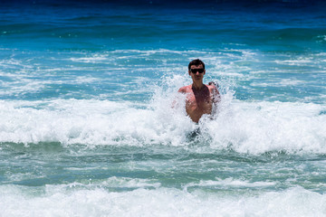 girl bathes in the ocean waves