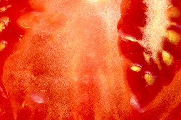 Slice of red tomato as background. Close-up