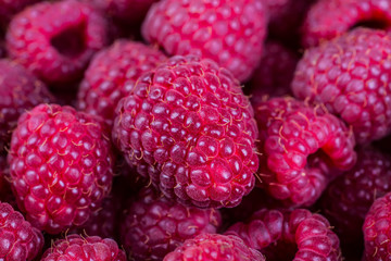 raspberries in a bowl on a wooden background