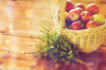 close up of melissa and basket with apples