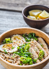 Bowl of chicken ramen soup on the wooden table