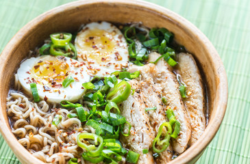 Bowl of chicken ramen soup on the wooden table