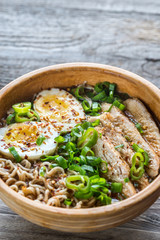 Bowl of chicken ramen soup on the wooden table