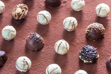 Chocolate candies on cocoa background