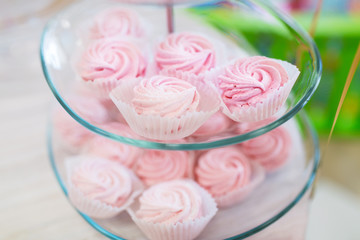 close up of custard sweets on glass serving tray