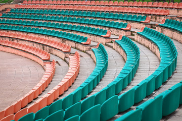 Naklejka premium Empty old plastic seats at stadium, open door sports arena.