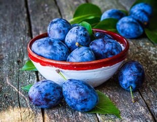fresh plums on wooden table