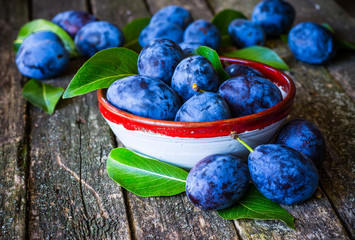 fresh plums on wooden table